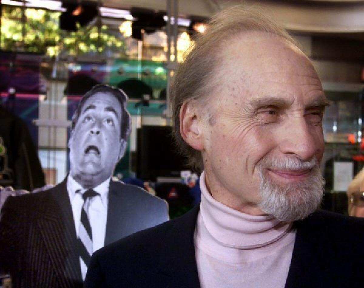 Sid Caesar stands in front of a cardboard cutout from one of his early programs as he waits for ceremonies honoring him as one of the first inductees into NBC's "Walk of Fame" in the network's Rockefeller Center store in New York in 1999.