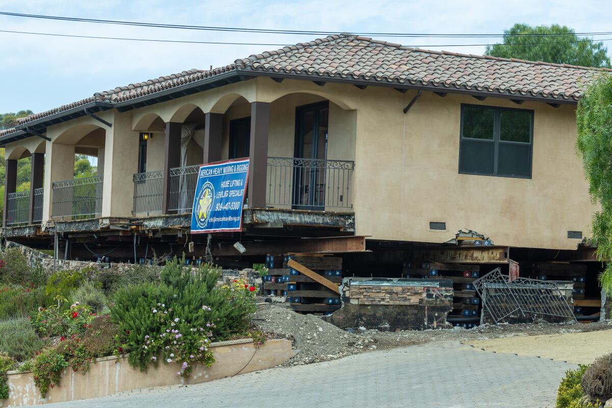 A view of a home that has to be lifted and leveled following land movement in a Portuguese Bend neighborhood.