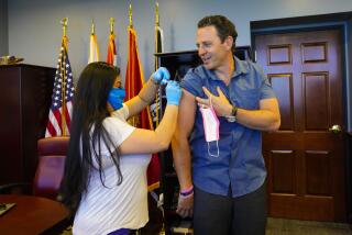 San Diego, CA - October 13: On Wednesday, Oct. 13, 2021 in San Diego, CA., Chair Nathan Fletcher took time to publicly receive his flu vaccine from Liza Parra, LVN with the County of San Diego. (Nelvin C. Cepeda / The San Diego Union-Tribune)