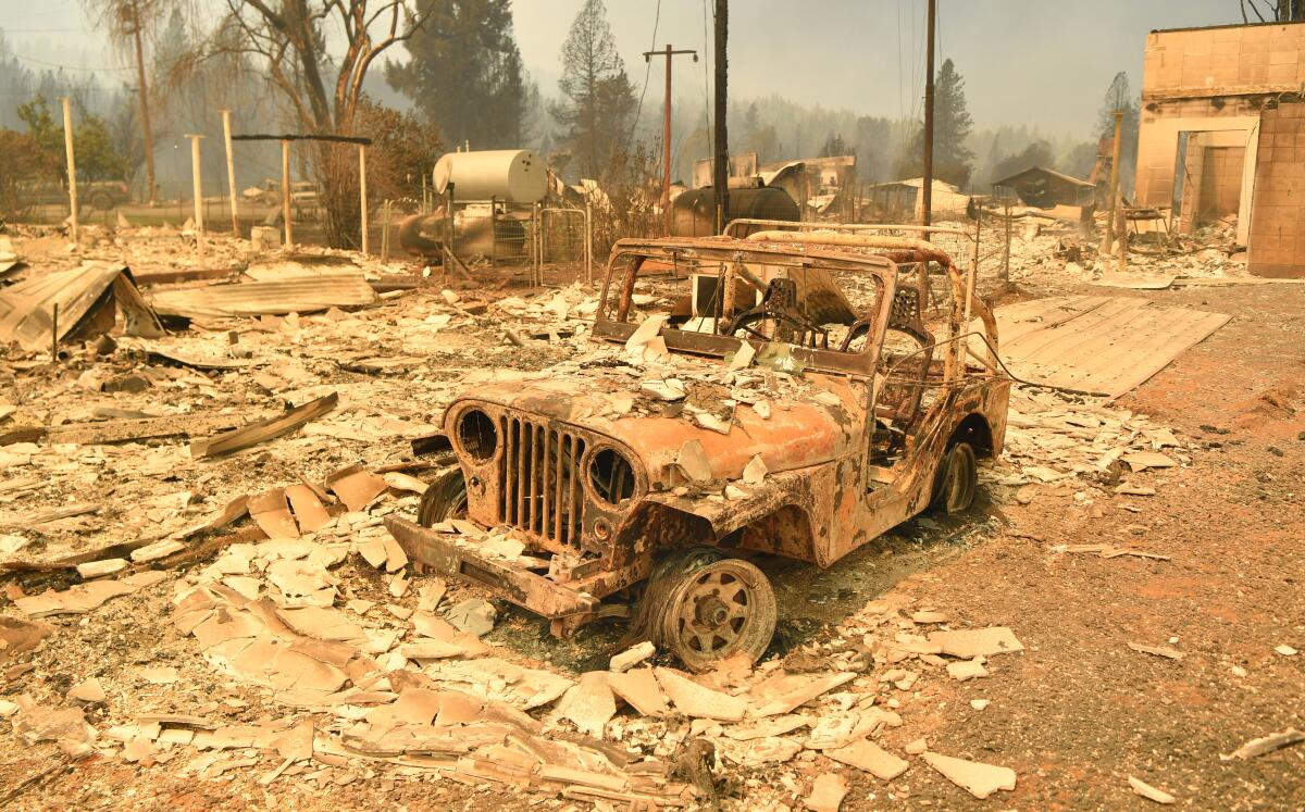 A burned Jeep  in a decimated downtown Greenville, Calif., during the Dixe fire