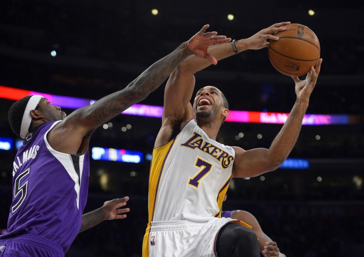 Forward Xavier Henry (7) shoots over Sacramento Kings forward John Salmons during the first half of the Lakers' 100-86 victory in November.