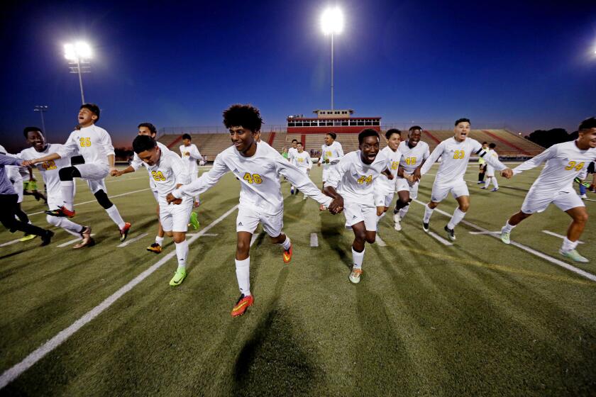 HOUSTON, TEXAS -- MONDAY, MARCH 20, 2017: Margaret Long Wisdom High School soccer players run off the field towards fans, celebrating an undefeated season after a 6-2 win against Stephen Pool Waltrip High School at Joe K. Butler Stadium in Houston, Texas, on March 20, 2017. Houston has become the most diverse city in the nation. (Gary Coronado / Los Angeles Times)
