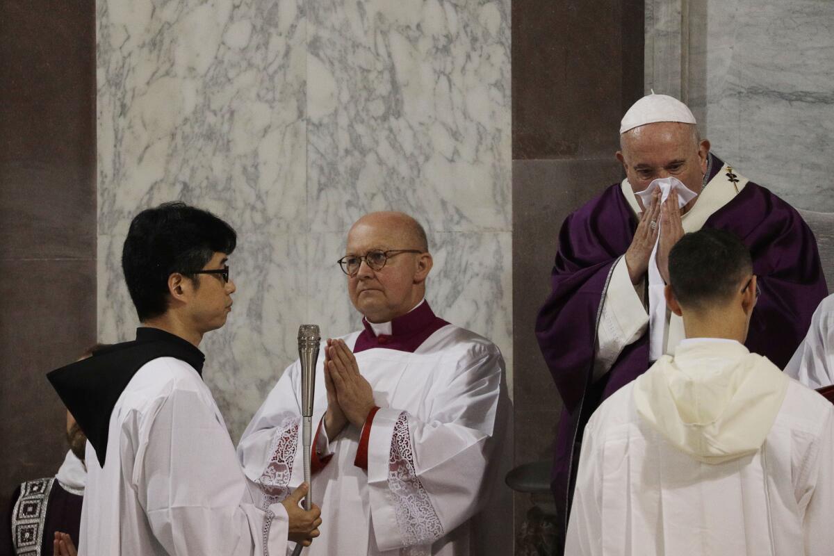 Pope Francis wipes his nose as he celebrates the Ash Wednesday Mass opening Lent, the 40-day period of abstinence and deprivation for Christians before Holy Week and Easter, in the Santa Sabina Basilica in Rome, on Wednesday.