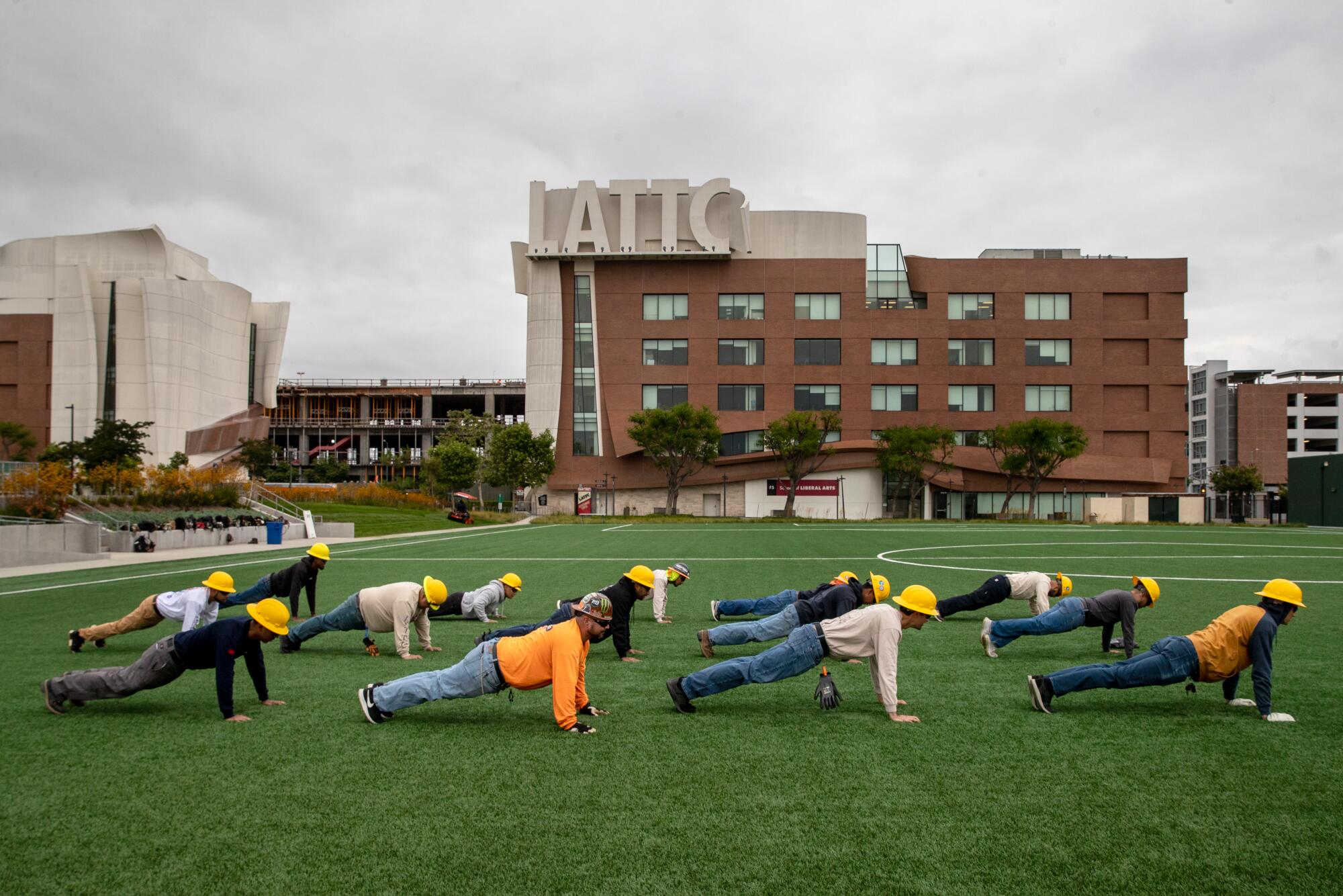 Students do exercises on a grassy field
