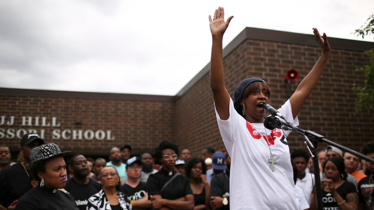 Diamond Reynolds, front right, addresses the crowd at JJ Hill Montessori Magnet School where mourners held a vigil Thursday in St, Paul, Minn., in response to the shooting death of Philando Castile by police.