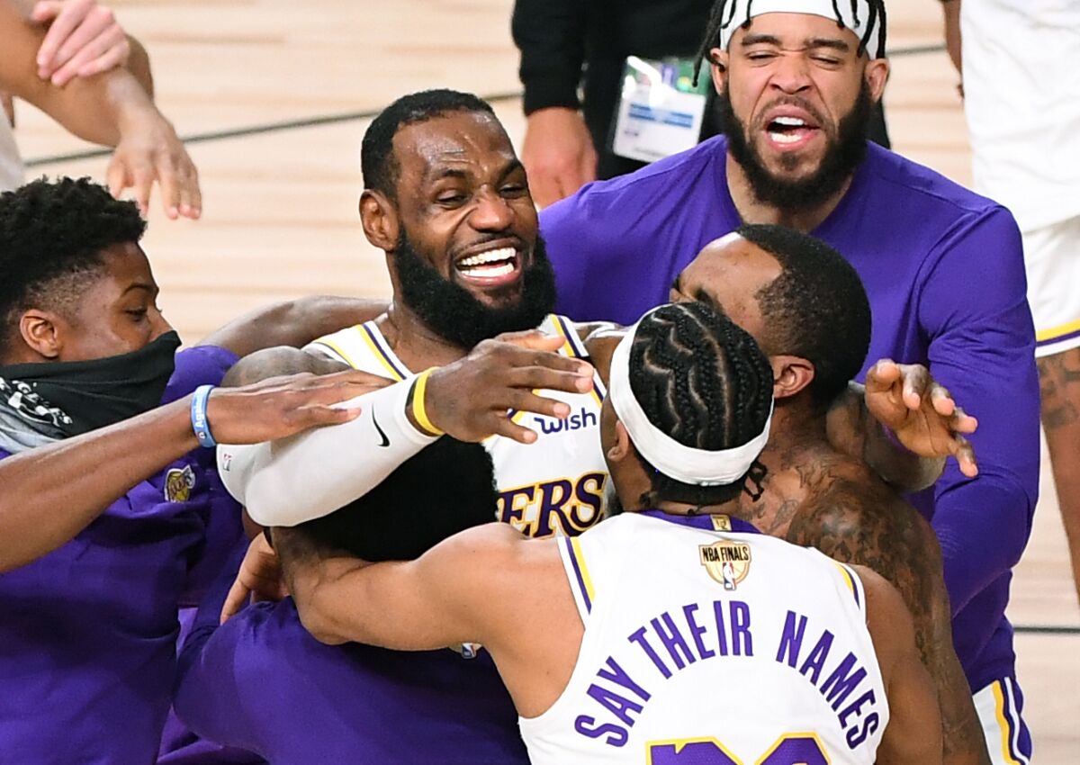 Lakers including LeBron James, center, celebrate.