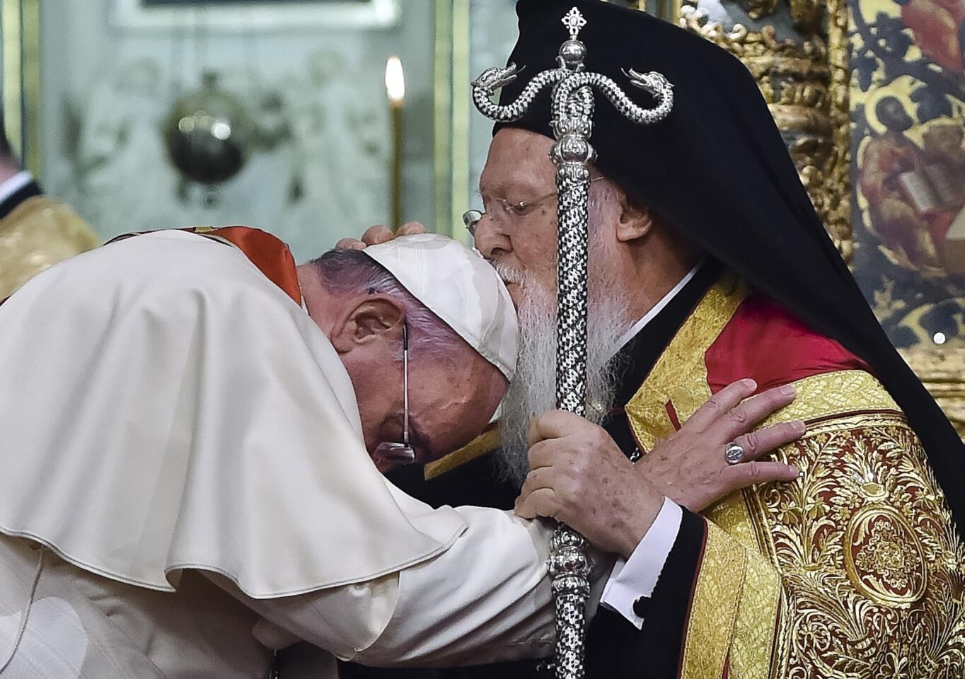 Ecumenical Patriarch Bartholomew I kisses Pope Francis' head during an ecumenical prayer at the Patriarchal Church of St. George in Istanbul in November.