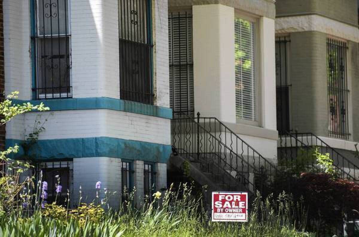Nationally, according to new data from the National Assn. of Realtors, 44% of all new listings take 90 days or more to sell, 22% take six to 12 months and 9% take more than a year. Above, sign stands within tall grass outside a home in Washington.