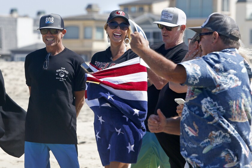 Carrie Purdy laughs after World Surfing Champion Peter 