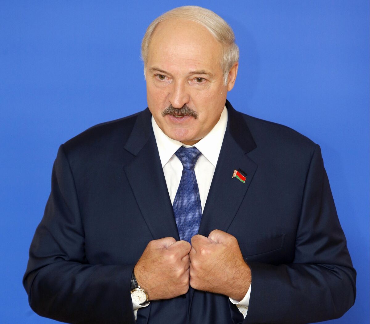 FILE - Belarusian President Alexander Lukashenko speaks to the media at a polling station after voting during the presidential election in Minsk, Belarus on Sunday, Oct. 11, 2015. For most of his 27 years as the authoritarian president of Belarus, Alexander Lukashenko has disdained democratic norms, making his country a pariah in the West and bringing him the sobriquet of “Europe’s last dictator." Now, his belligerence is directly affecting Europe. (AP Photo, File)