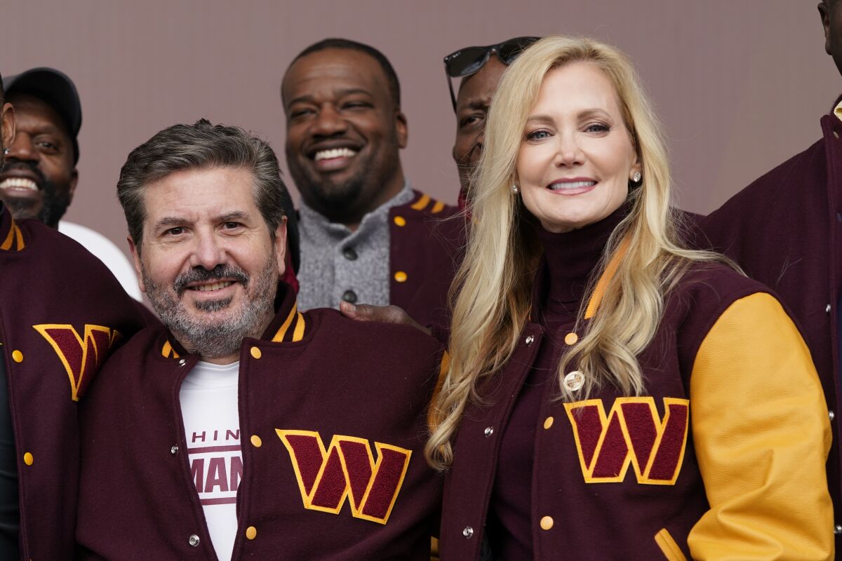 Dan and Tanya Snyder, co-owner and co-CEOs of the Washington Commanders, pose in team jackets.