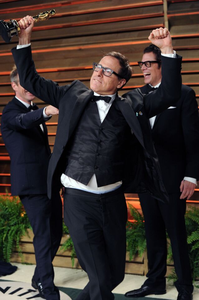 David O. Russell poses with Spike Jonze's Oscar at the 2014 Vanity Fair party.