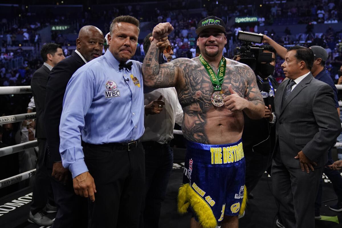 Andy Ruiz, Jr., right, celebrates after winning a WBC world heavyweight title eliminator.