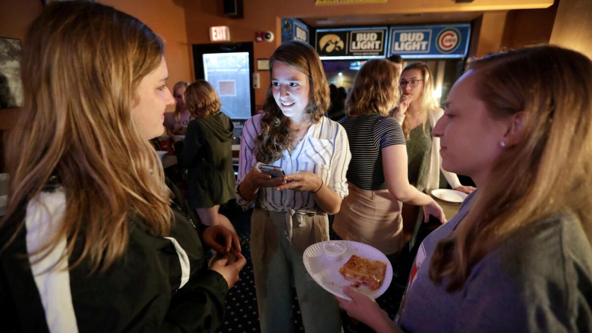 Hillary Clinton campaign staffer Emma March Barash, center, talks with University of Iowa students in Iowa City this month.