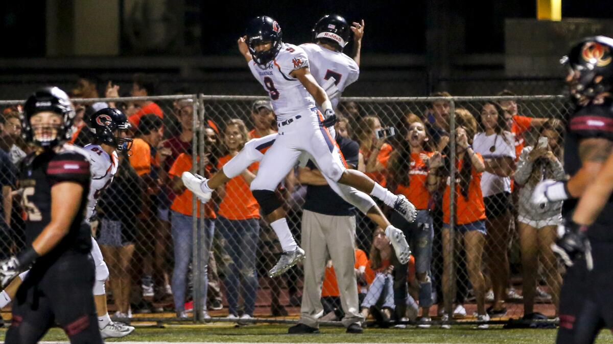 Chaminade receiver Michael Wilson (9) celebrates with quarterback Brevin White after a 36-yard touchdown pass Friday night against Oaks Christian.