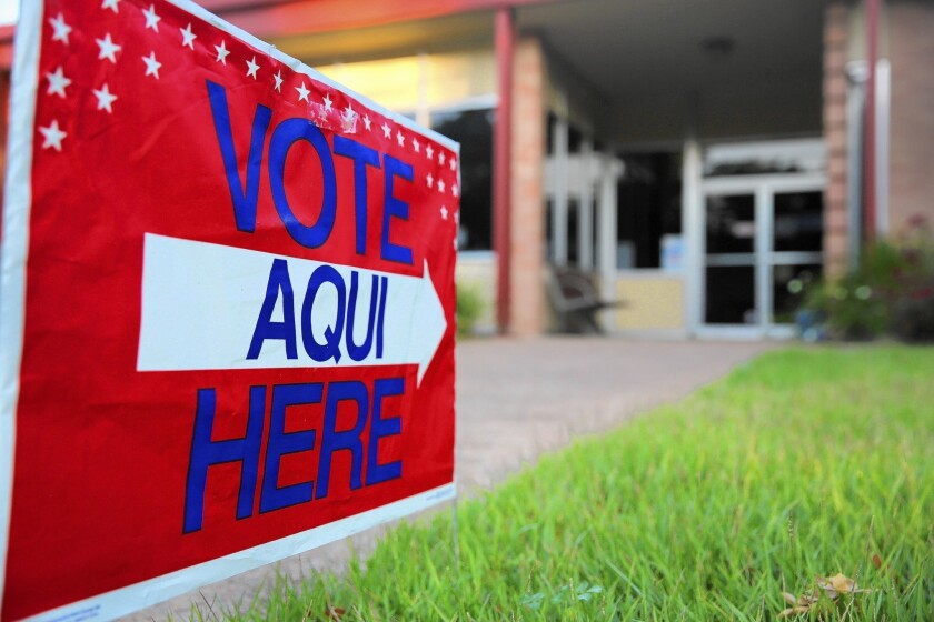 A bilingual sign points to a polling station in Austin, Texas.