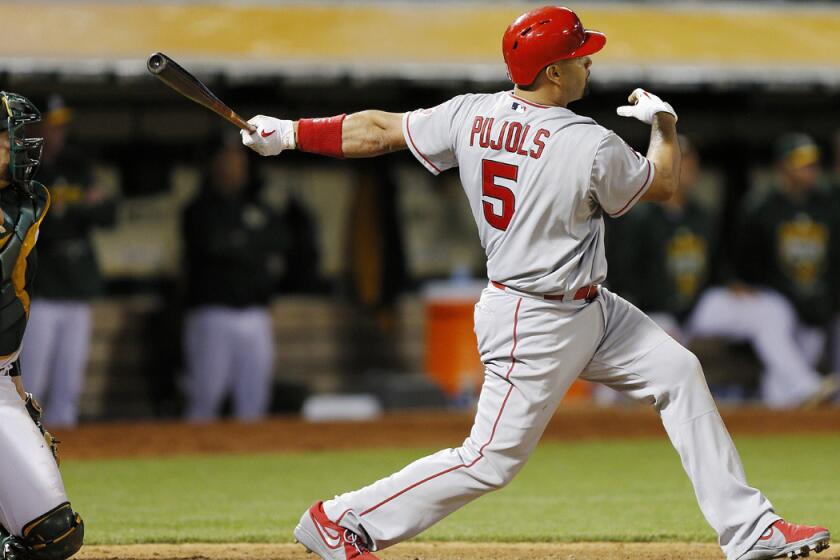 Angels' Albert Pujols hit a grand slam against the Oakland A's in the seventh inning on Friday. Angels won 12-7.
