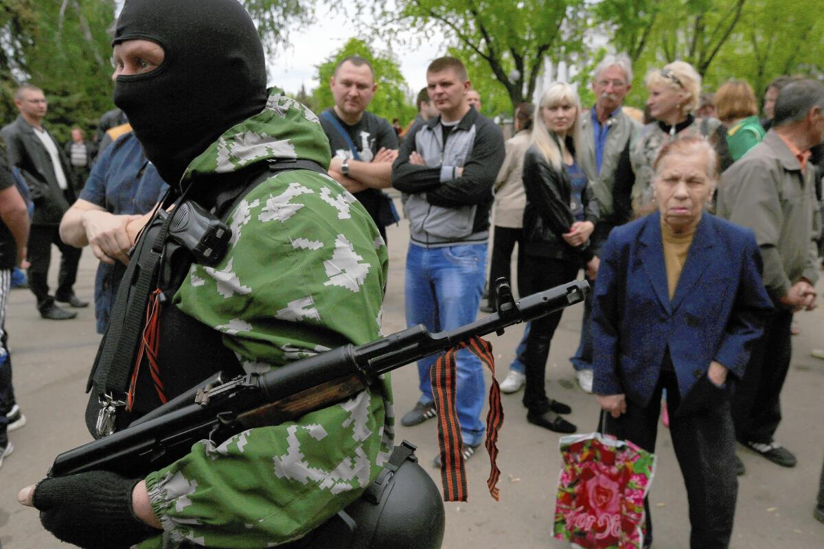 A separatist gunman code-named Spets is among the mourners at the funeral for a nurse slain in fighting between troops and rebels in Kramatorsk, near Slovyansk.