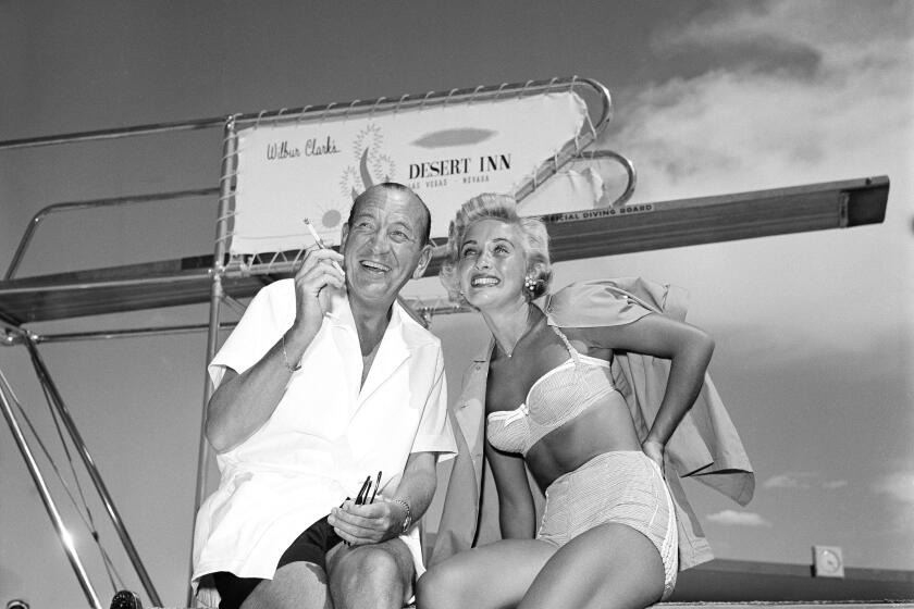 Noel Coward and Jane Powell relax in the sun at Las Vegas, Nevada, June 20, 1955, where the Hollywood actress closed and where the English playwright and actor is currently appearing in his first night club appearance. (AP Photo)