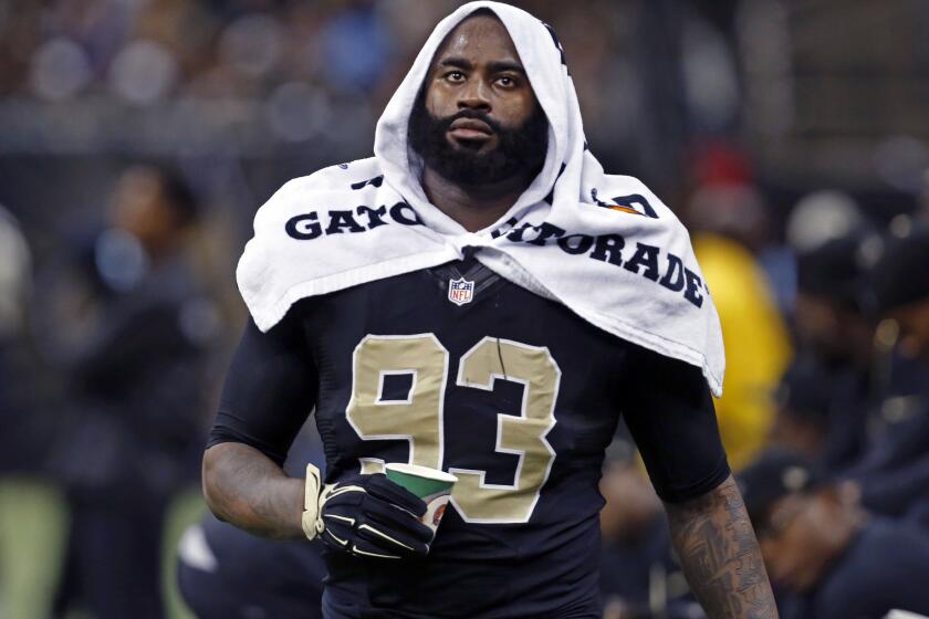 New Orleans Saints linebacker Junior Galette walks along the sideline during the second half of a game against the Baltimore Ravens on Nov. 24.