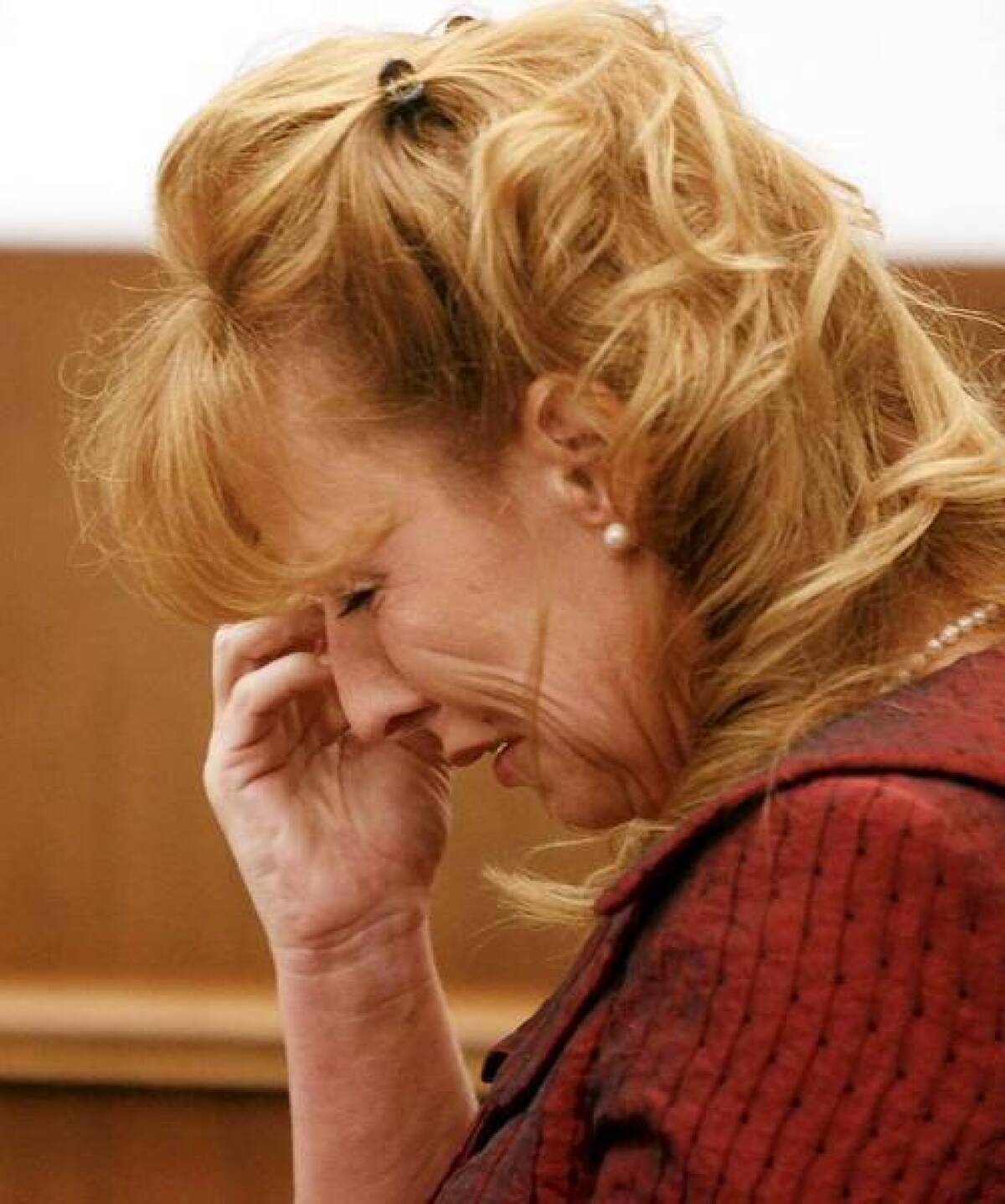 Brinda Sue McCoy cries in court after being found guilty in June of five felony counts of assault with a semi-automatic firearm on a peace officer and one felony count of discharging a firearm with gross negligence with sentencing enhancements.