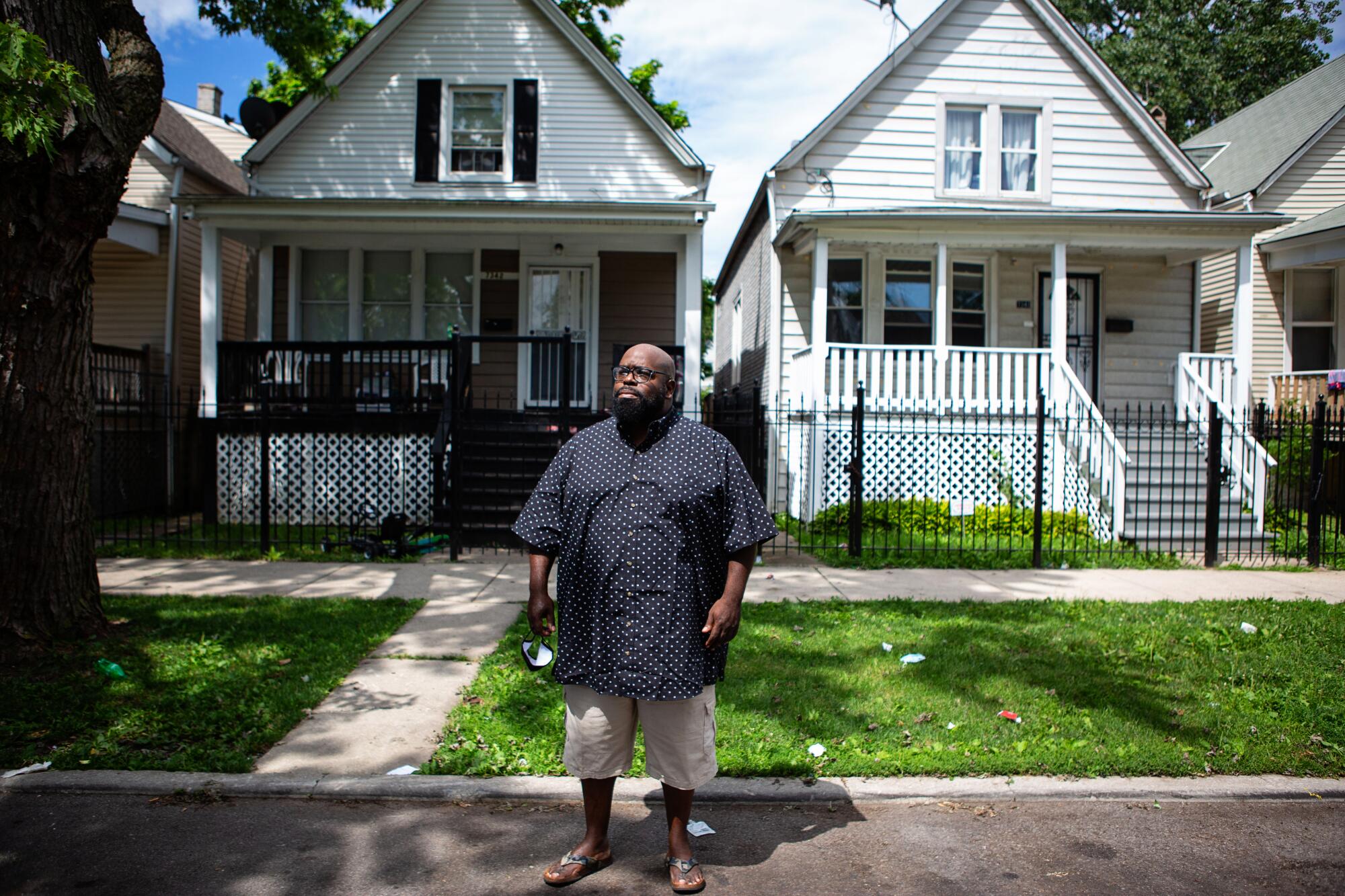 Donovan Price stands in front of the home where 13-year-old Deon Williams was shoot and killed.