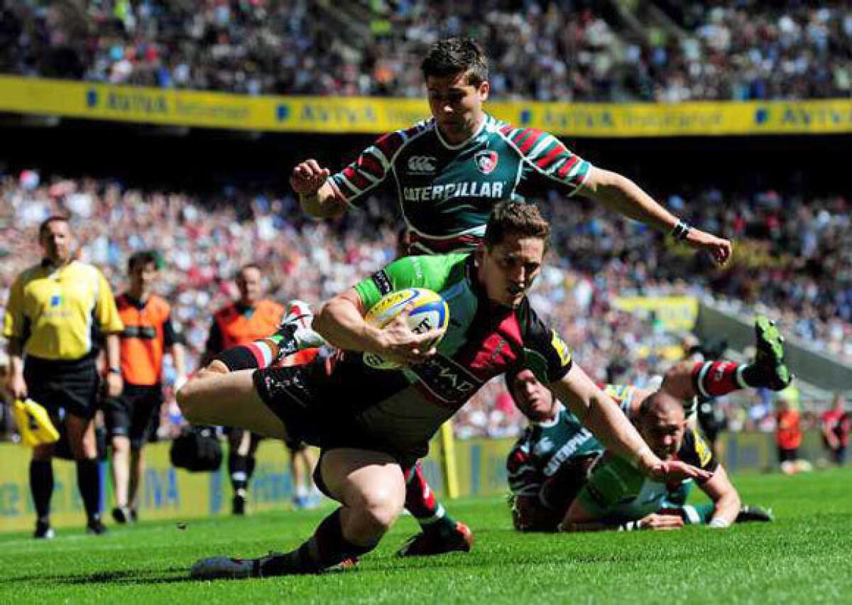 Tom Williams of Harlequins goes past the challenge from Ben Youngs of Leicester to score dur on May 26.