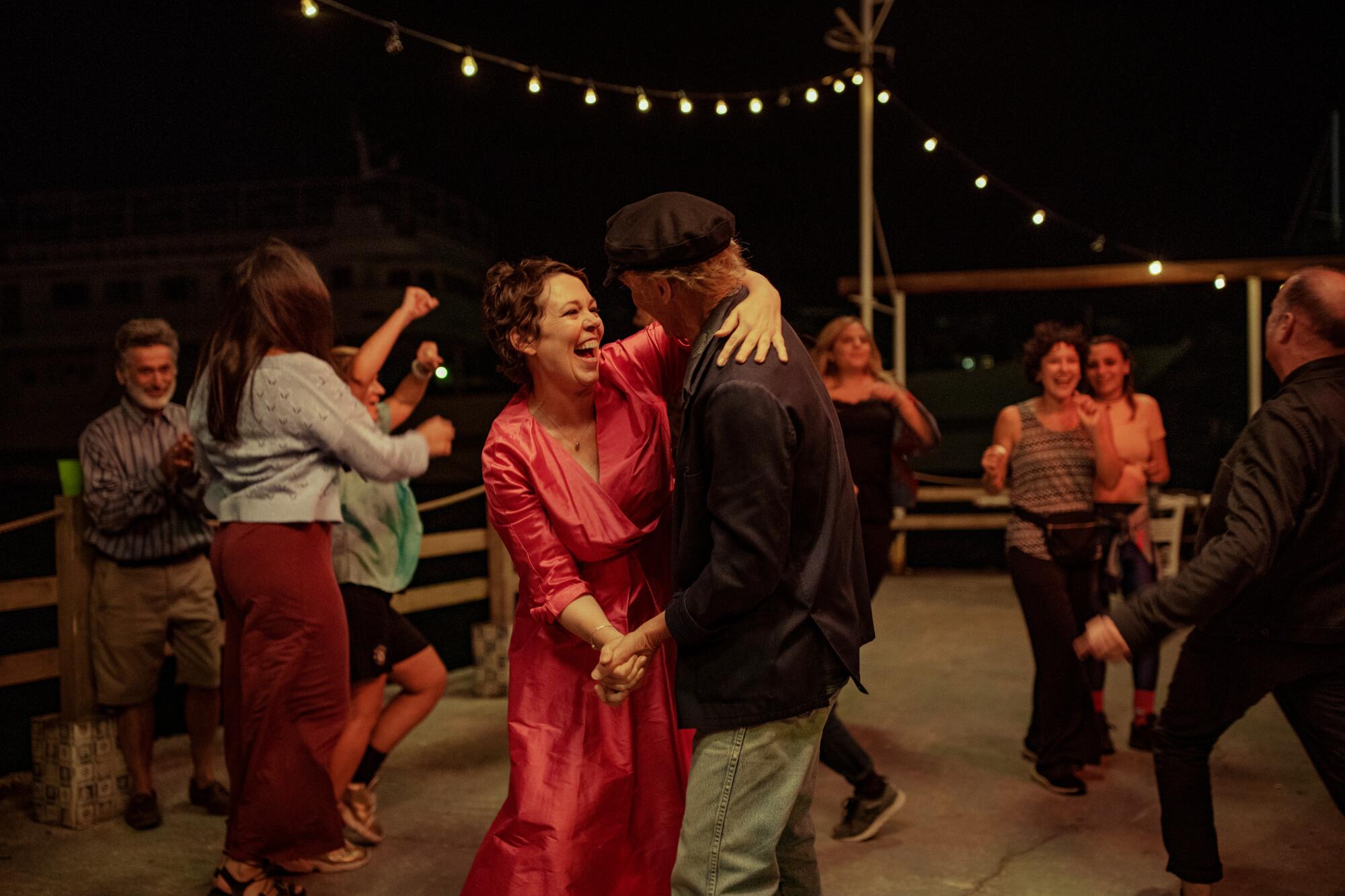 Olivia Colman and Ed Harris dance in a scene from "The Lost Daughter."