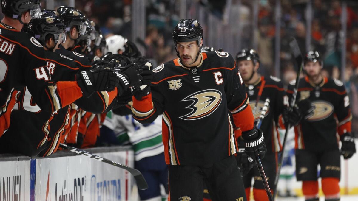 Ducks center Ryan Getzlaf is congratulated by teammates after scoring against the Canucks during the first period Wednesday.