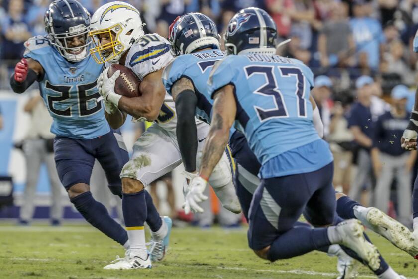 NASHVILLE, TN, SUNDAY, OCTOBER 20, 2019 - Los Angeles Chargers running back Austin Ekeler (30) avoids tacklers on a run near the goal line late in the game against the Tennessee Titans at Nissan Stadium. (Robert Gauthier/Los Angeles Times)