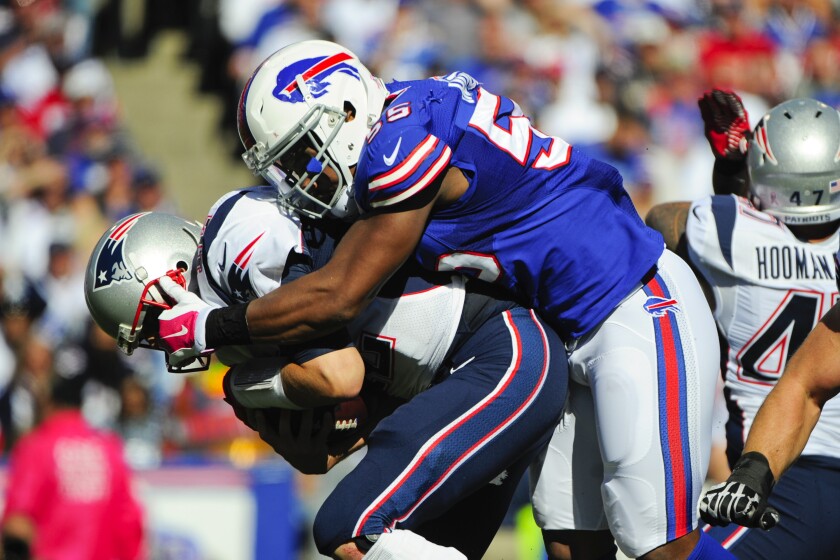 FILE - In this Oct. 12, 2014, file photo, Buffalo Bills defensive end Jerry Hughes (55) sacks New England Patriots' Tom Brady (12) during the first half of an NFL football game in Orchard Park, N.Y. If this is the end of the line for Jerry Hughes’ career, the Buffalo Bills defensive end is primed for the playoffs. Whether it’s facing the arch-rival New England Patriots for a third time in seven weeks or the prospect of playing in potentially sub-0 temperatures on Saturday night, the 12th-year player is taking both head on. (AP Photo/Gary Wiepert, File)