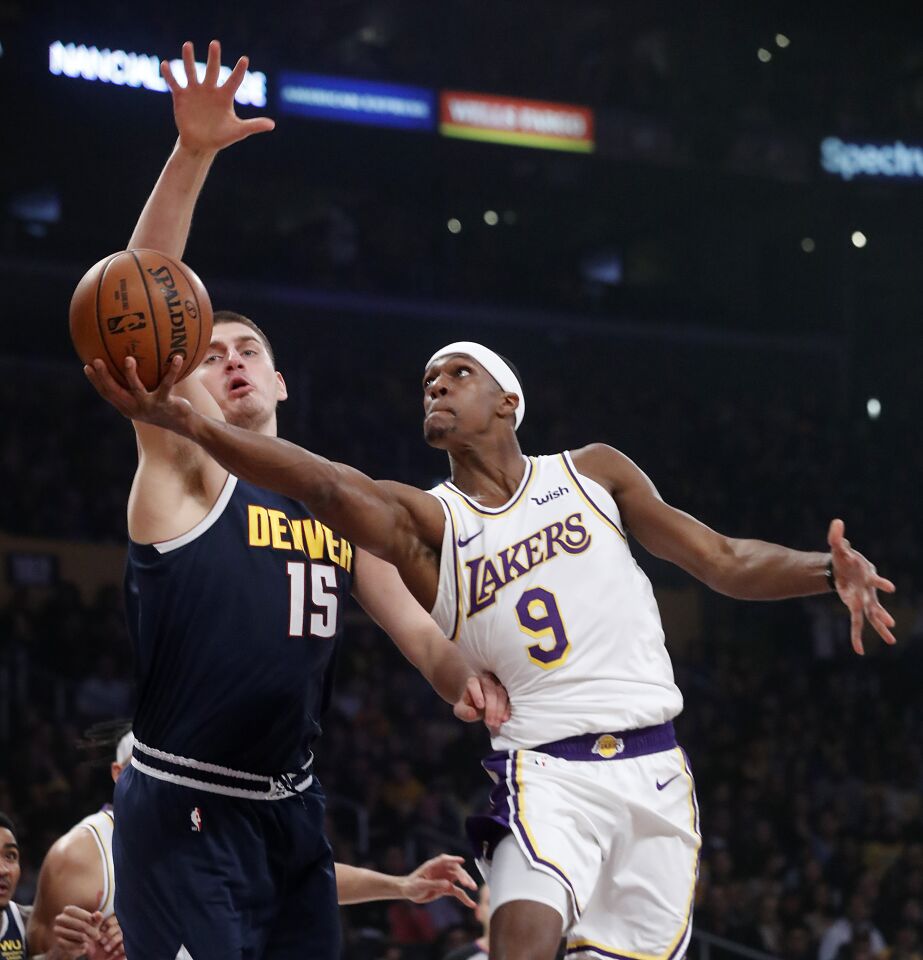 LOS ANGELES, CALIF. - DEC. 22, 2019. Lakers guard Rajon Rondo goes to the baket against Nuggets center Nikola Jokic in the first quarter Sunday night, Dec. 22, 2019, at Staples Center in Los Angeles (Luis Sinco/Los Angeles Times)