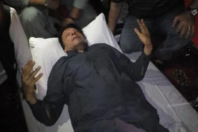 In this photo released by former Pakistani Prime Minister Imran Khan's party, Pakistan Tehreek-e-Insaf, Imran Khan, who injured in a shooting incident, is seen after the incident, in in Wazirabad, Pakistan, Thursday, Nov. 3, 2022. A gunman opened fire at a campaign truck carrying Khan on Thursday, wounding him slightly and also some of his supporters, a senior leader from his party and police said. (Pakistan Tehreek-e-Insaf via AP)
