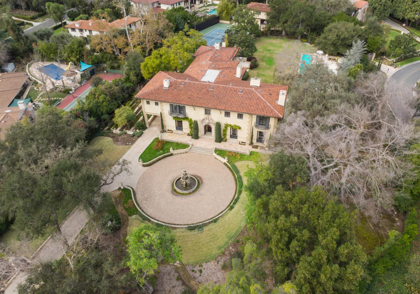 Aerial view of the mansion, its circular motor court and surrounding trees.