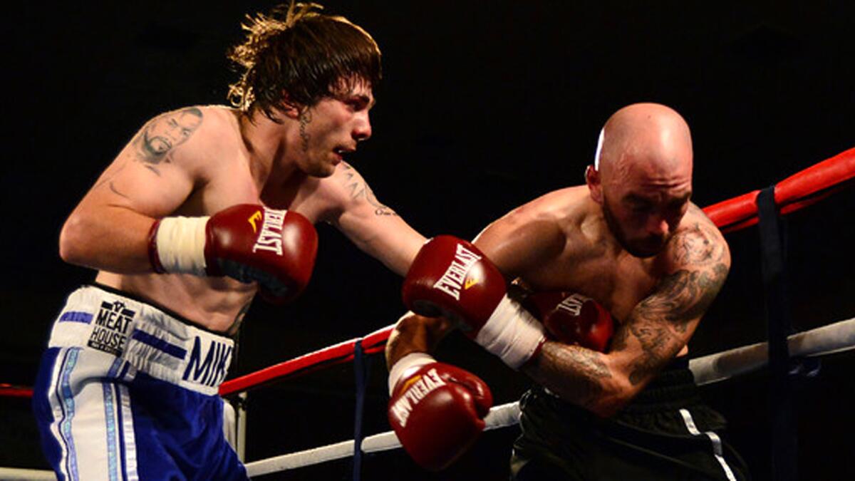 Mike Towell, sporting a Mike Tyson tattoo on his right shoulder, lands a left against Danny Little during a fight in 2015.