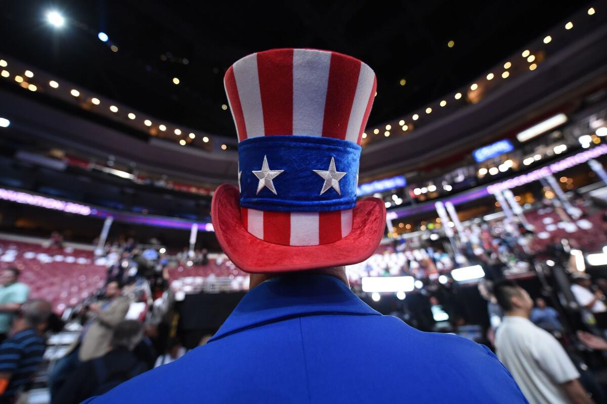 A man dressed in the national colors looks over the convention floor on Day 1 of the 2016 Democratic National Convention in Philadelphia.