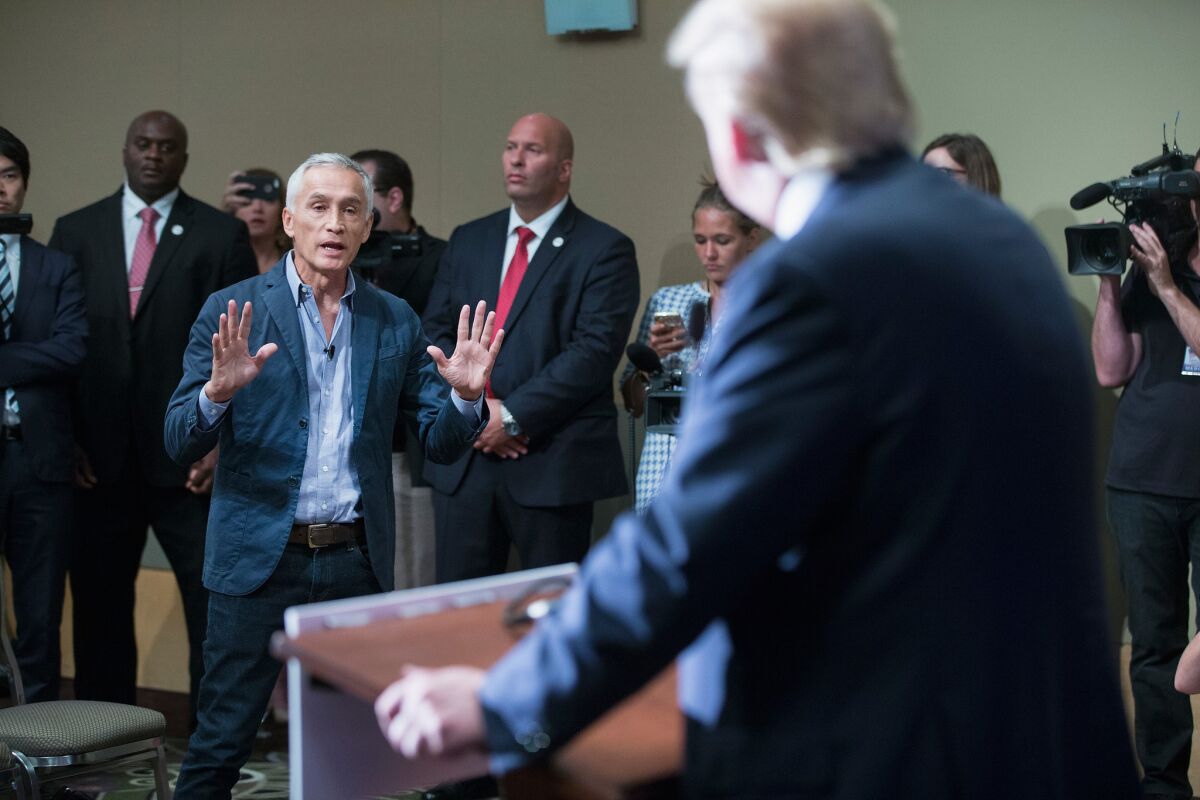 Republican presidential candidate Donald Trump fields a question from Univision and Fusion anchor Jorge Ramos during a news conference held before his campaign event. Earlier in the news conference Trump had Ramos removed from the room after he failed to yield when Trump wanted to take a question from a different reporter.