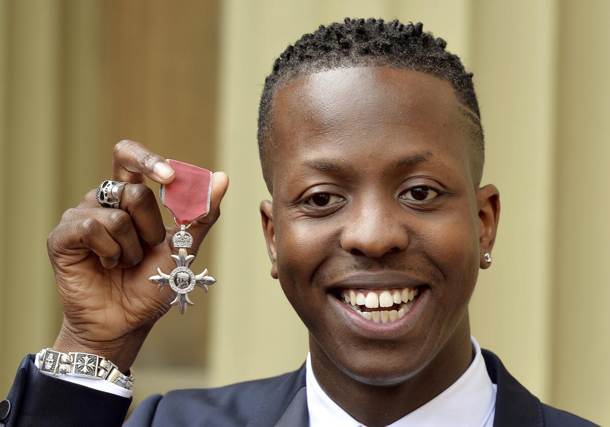 Jamal Edwards holding up a British medal