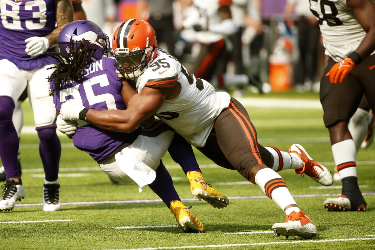 Minnesota Vikings running back Alexander Mattison is tackled by Cleveland Browns defensive end Myles Garrett.