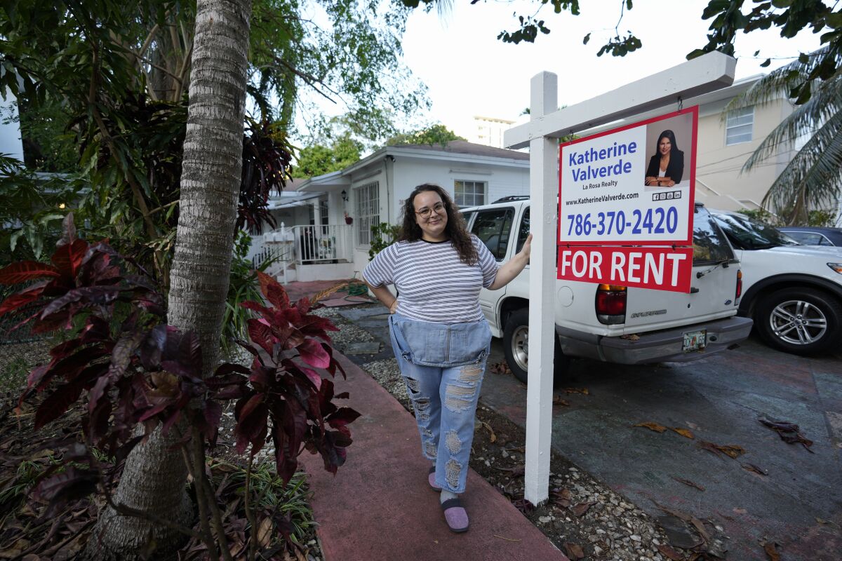 Krystal Guerra, 32, poses next to a for rent sign.