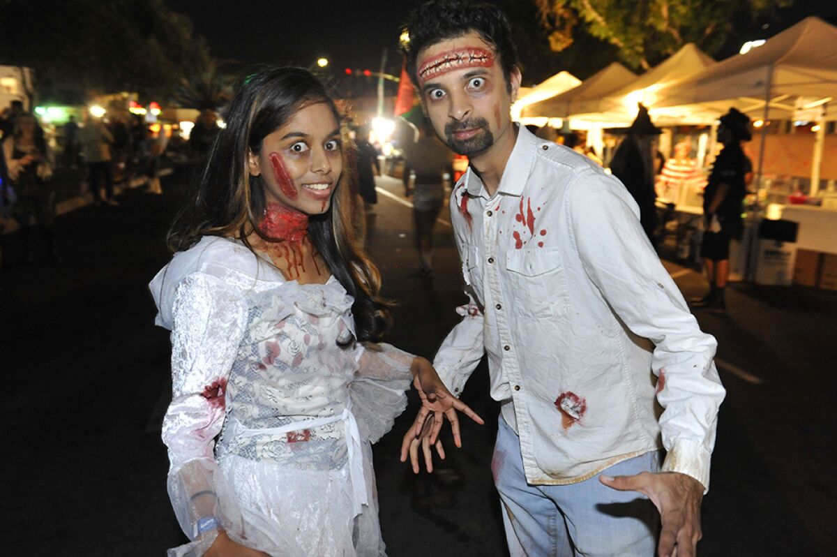 A woman and man dressed as zombies for Halloween