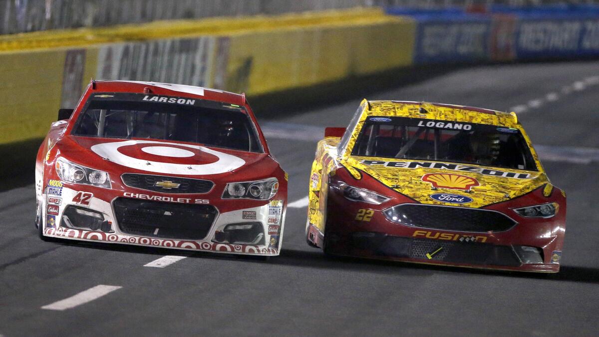 NASCAR driver Kyle Larson tries to get his No. 42 Target Chevrolet past Joey Logano in the No. 22 Shell Pennzoil Ford near the end of the Sprint Cup Series race Saturday night at Charlotte Motor Speedway.