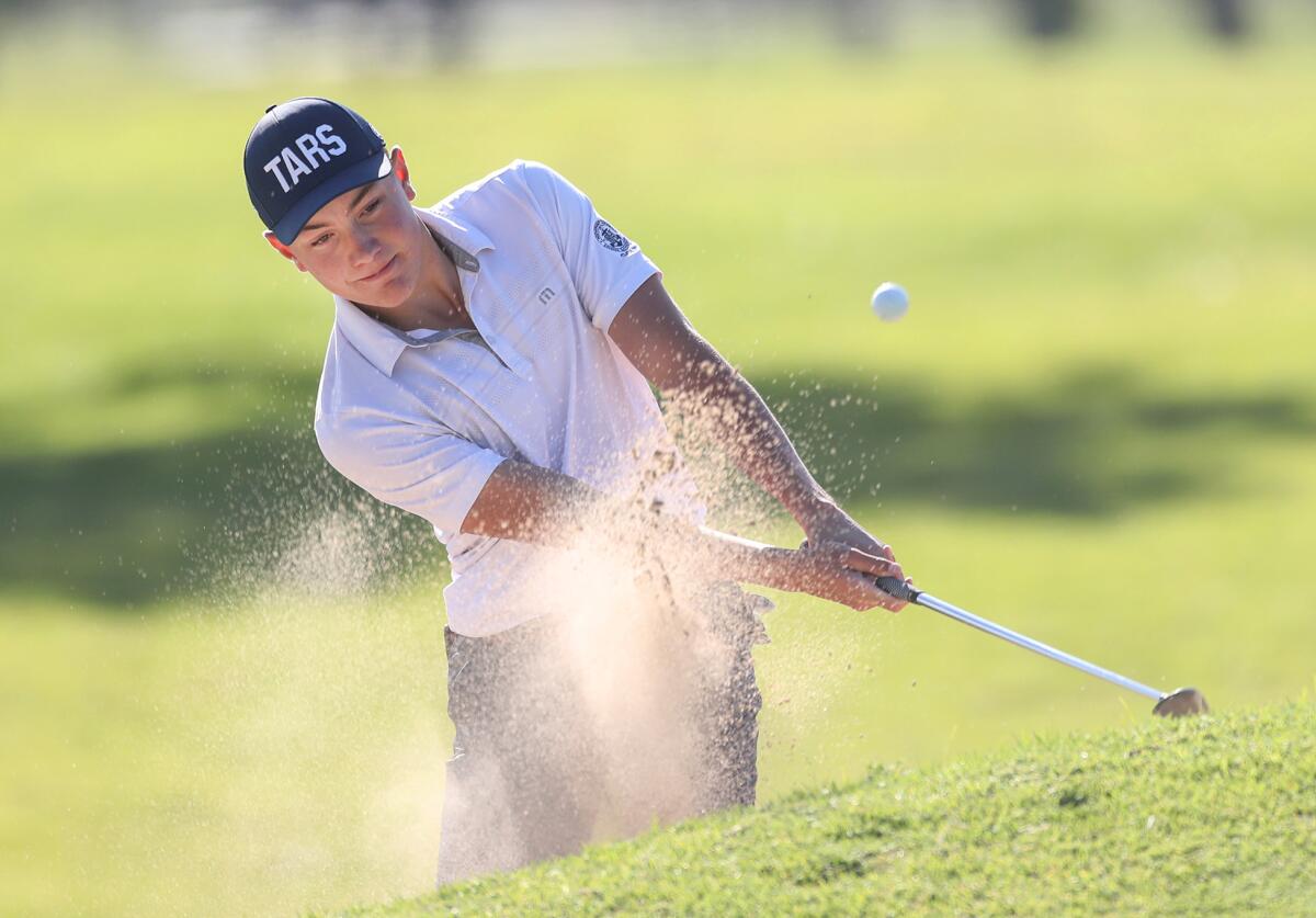 Zack Moreau of Newport Harbor hits from the green side bunker during the Battle of the Bay boys' golf match on Wednesday.