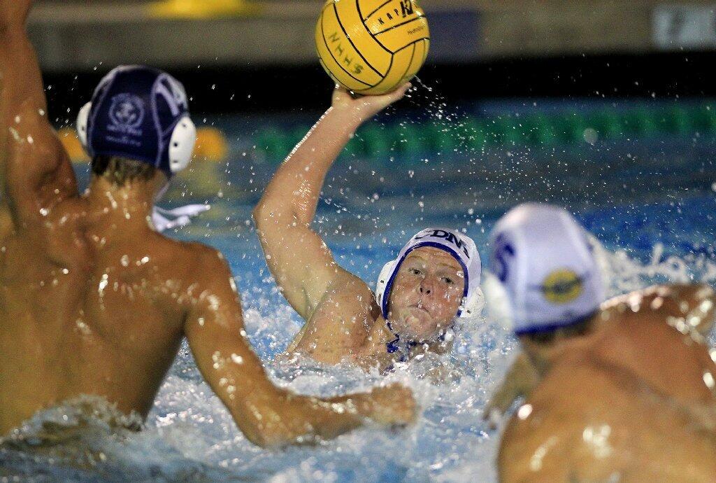 Corona del Mar High's Garrett Spruth, center, competes during the second half against Newport Harbor in the Battle of the Bay game on Saturday.