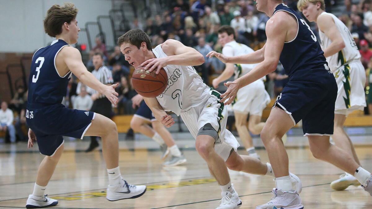 Edison High senior guard Kaden Headington (2), shown playing against Newport Harbor on Jan. 16, helped the Chargers earn a share of the Surf League title.