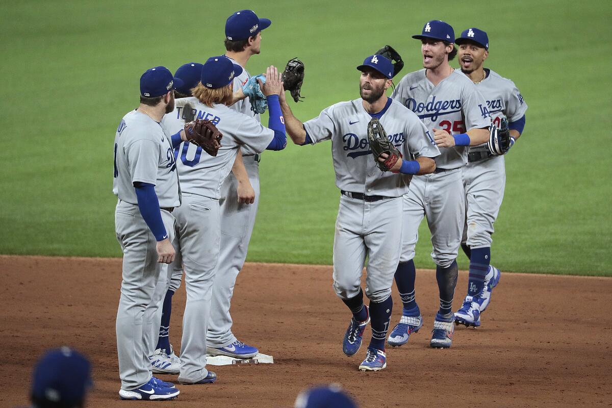 Arlington, Texas, Thursday October 8, 2020. Chris Taylor, Cody Bellinger and Mookie Betts celebrate.