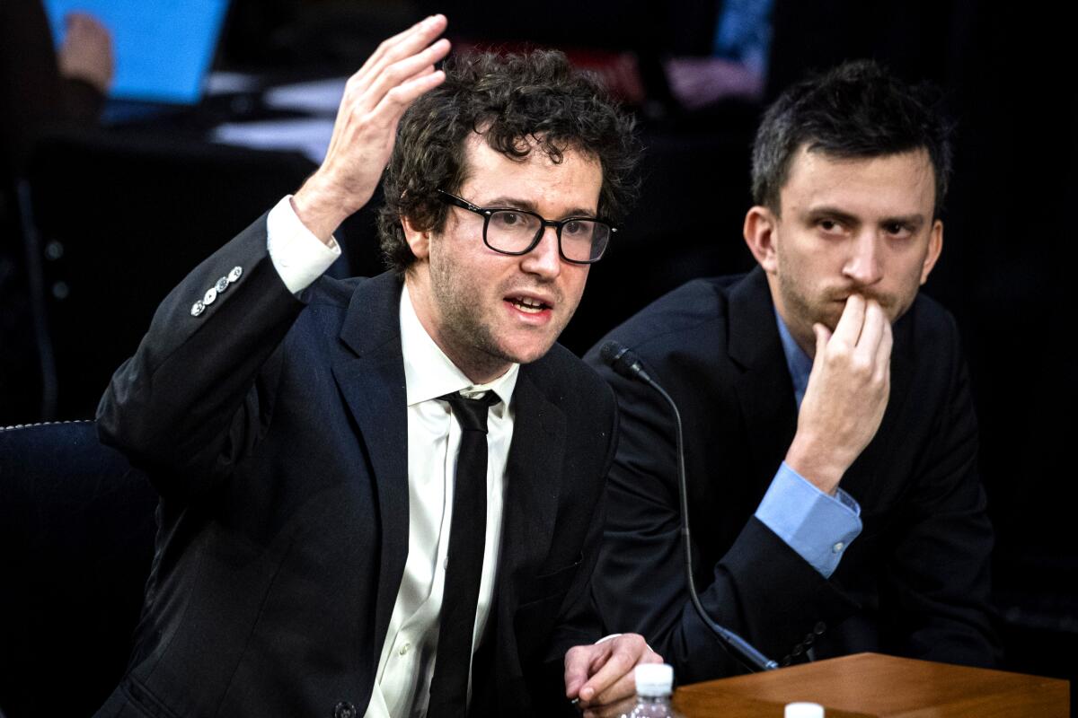 A young musician in a suit testifies in front of a congressional committee.