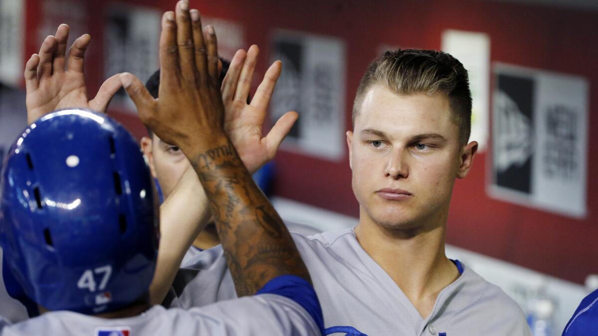 Dodgers center fielder Joc Pederson congratulates second baseman Howie Kendrick for scoring a run during a game against the Arizona Diamondbacks on July 1.