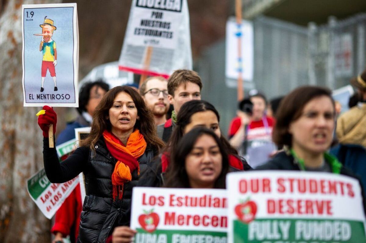 Educators, parents, students and supporters picket in support of UTLA outside Eagle Rock Jr./Sr. High School, on Tuesday.
