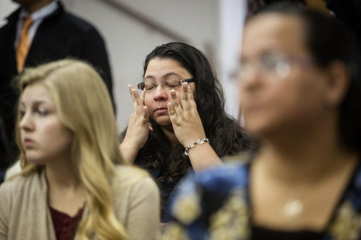 Anita Hernandez wipes away tears as names of the victims killed in the Ft. Hood shooting are read aloud Sunday during a memorial service at the Tabernacle Baptist Church in Killeen, Texas.